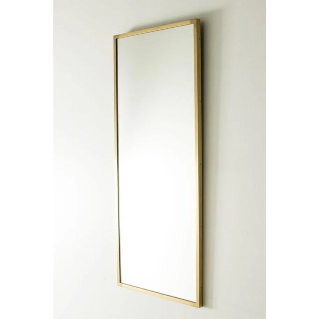 Elegant wall mirror by Hans-Agne Jakobsson in a sleek, rectangular design. Brushed brass frame. This piece has an...