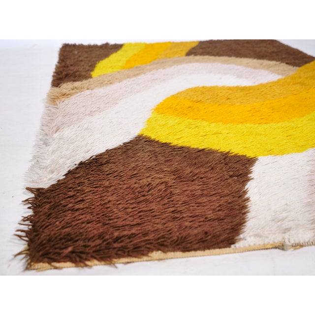 Vintage Space Age wool rug by Desso from the 1970s with an abstract, curved design in shades of brown, beige, and yellow....