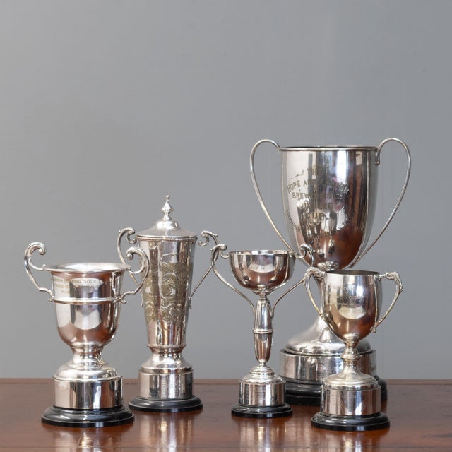 Collection of five 20th century silver plated trophies, re-polished with pine bases. Measurements to the largest. U.K...