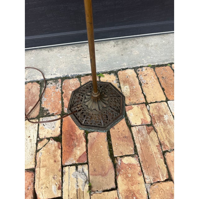 An elegant early 20th-century bridge arm floor lamp featuring elaborate cast-metal ornamentation, an octagonal pierced...