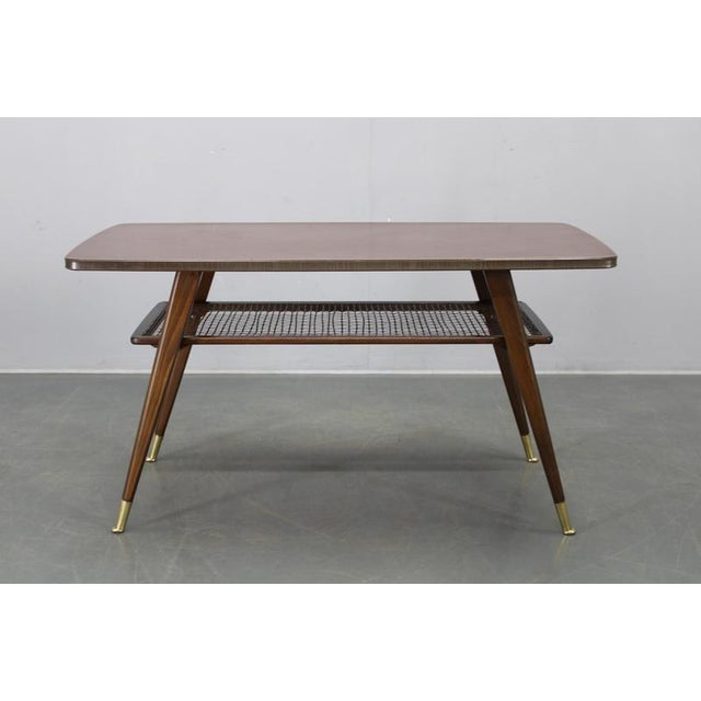This Mid Century Modern coffee table, produced in Germany during the 1960s, represents classic European modernist...