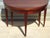 Beautiful Empire-style mahogany half-moon console table with six square, tapered legs mounted on gilt brass feet. This...