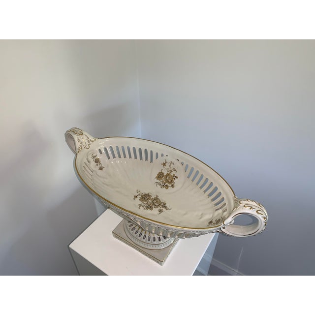 Large white porcelain dish with gold painted flowers. Great as an accent dish or to put fruit or flowers in!