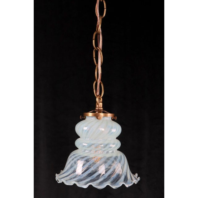 Art Nouveau glass shade hanging light, with a clockwise opal glass swirl and a scalloped edge. This requires one standard...