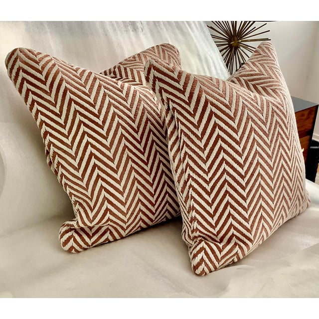 This product is a set of two sienna and white herringbone jacquard decorative pillow covers, measuring 18 inches in size....
