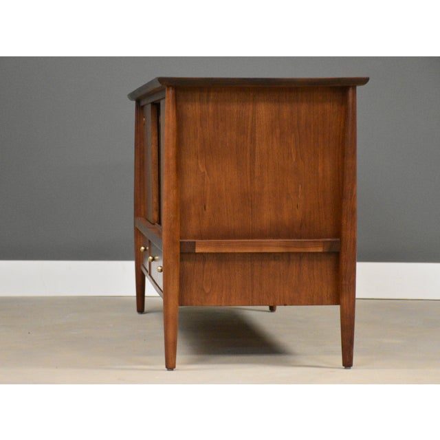 A mid century modern walnut three sliding door credenza made by Mt. Airy retailed by John Stuart. Finished back great for...