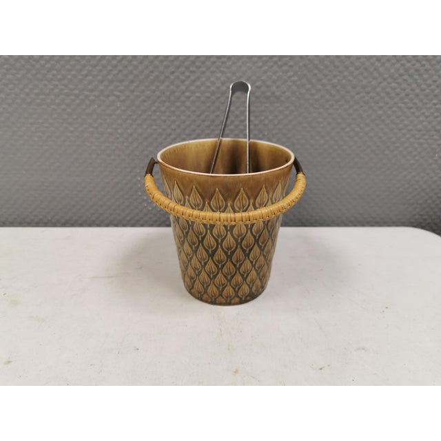 Ice bucket made of ceramic stoneware designed by Jens H Quistgaard. The "Relief" series was designed for Kronjyden Nissen...