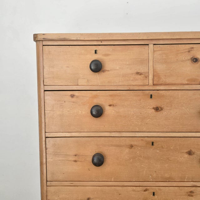 Dimensions: 20"D x 48.25"W x 43.75"H A warm honey toned antique pine chest of drawers, beautifully aged with the quiet...