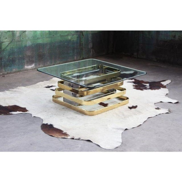 This one is a stunner!! This can be used as a Cocktail or Coffee table and features a Stacked Chrome and Brass base and a...