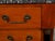 A French Empire style walnut commode from the early 20th century, with grey veined marble top four drawers and black...