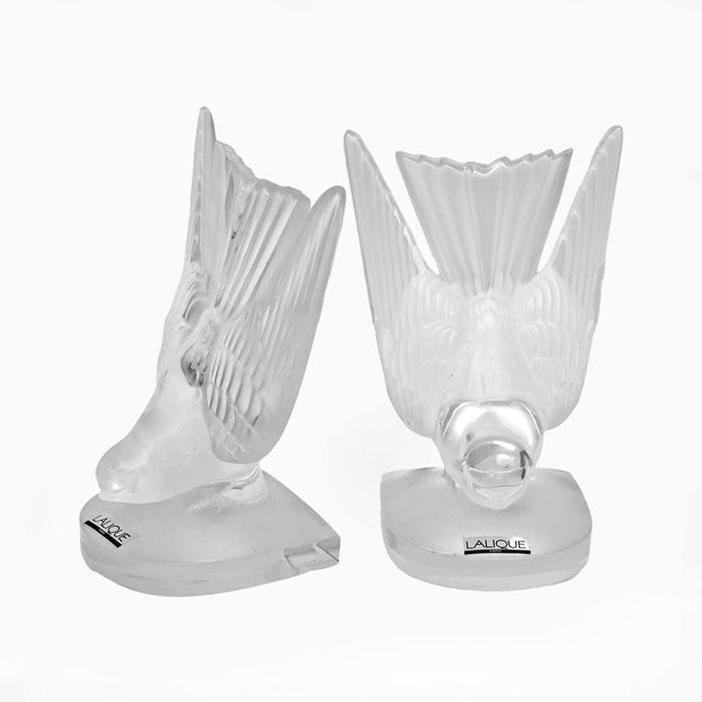 Splendid and elegant pair of hirondelles/swallows bookends, in frosted crystal, signed Lalique, France, circa 1980s. The...