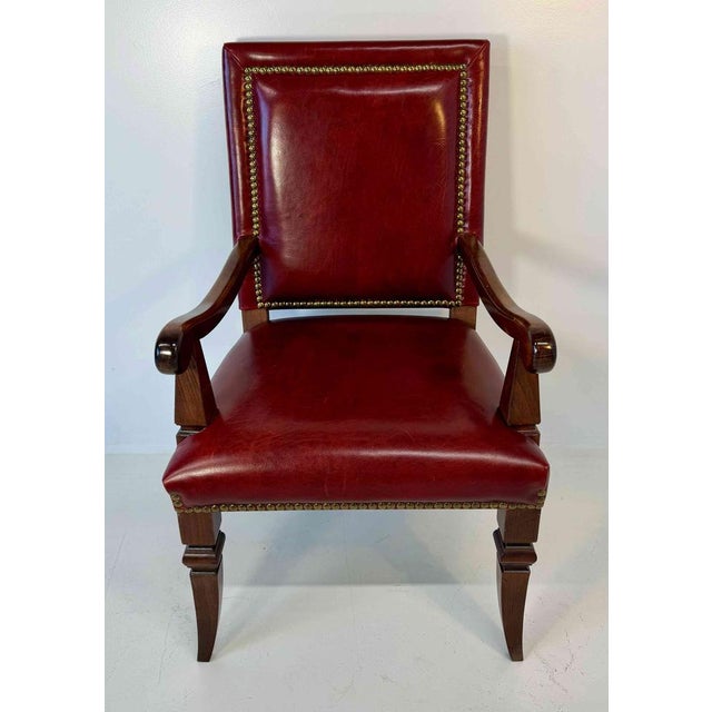 Striking Empire style throne armchair produced in the 1980s, featuring a solid beechwood structure and red leather...