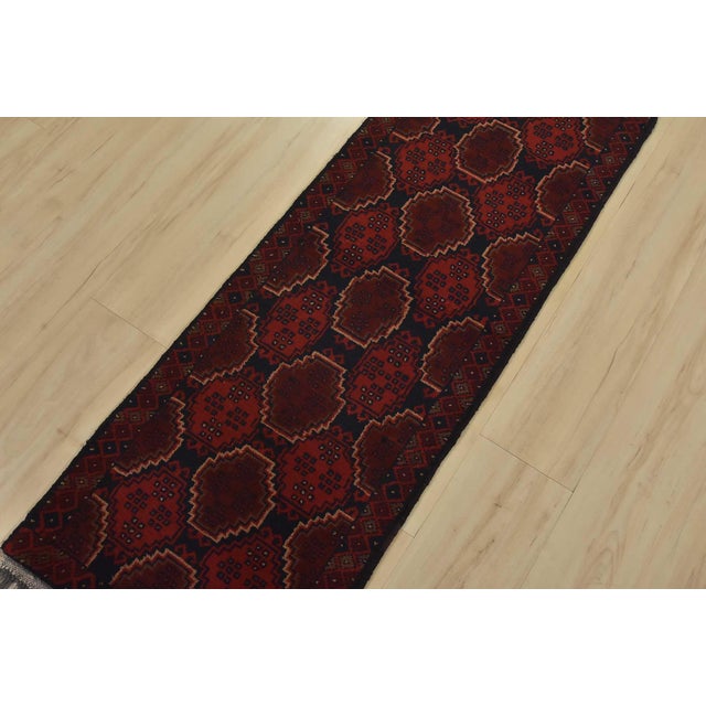 An authentic tribal Turkmen runner hand-knotted with an all-wool pile on a cotton foundation. This oriental rug features...