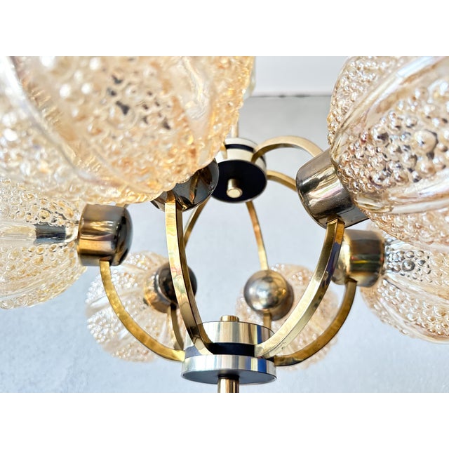 Beautiful mid - Century design. 1970s sputnik lamp made by German Kaiser Leuchten. Brass base with 6 amber colored opaline...