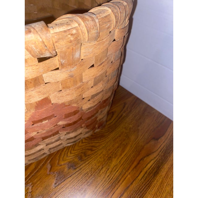 An authentic, early 20th-century American primitive splint wood gathering basket. This rugged, utilitarian piece features...