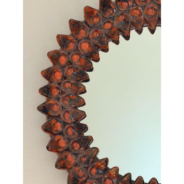 Sculptural vintage French wall mirror with a three-dimensional relief frame in warm brown and amber tones. The reverse...