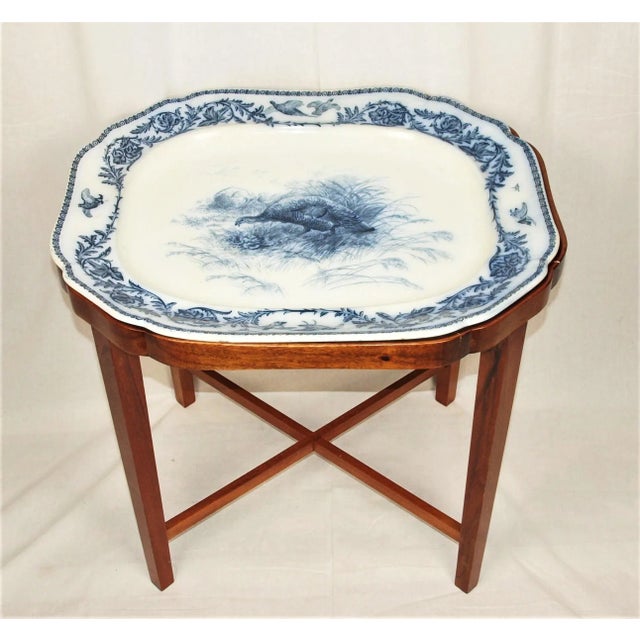 A large antique ceramic platter which rests inside a custom-made mahogany table. Platter is from the 1880’s and made by...