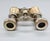 A charming pair of antique opera glasses with fluted mother-of-pearl barrels and silver-tone metal fittings, featuring a...