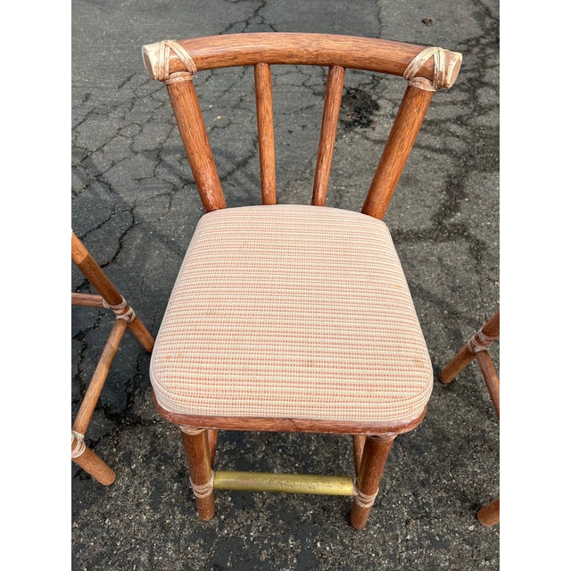 Authentic set of five vintage McGuire Furniture Co. bar stools, handcrafted in San Francisco and retaining their original...