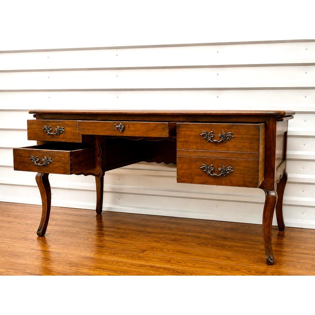 Handsome and practical best describe this wide French writing desk. Made of cherry wood, this desk features 2 side drawers...