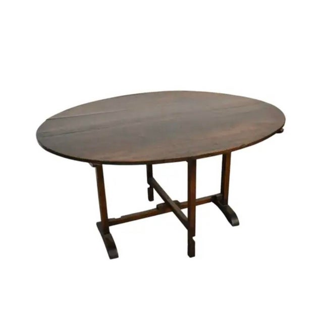 Rustic Oval Walnut French Tavern Tilt-Top Table. Table is generously proportioned oval plank topped, with beautifully...