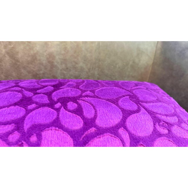 A cut velvet lumbar cushion cover in vibrant magenta-purple, with an all-over teardrop and petal composition across the...