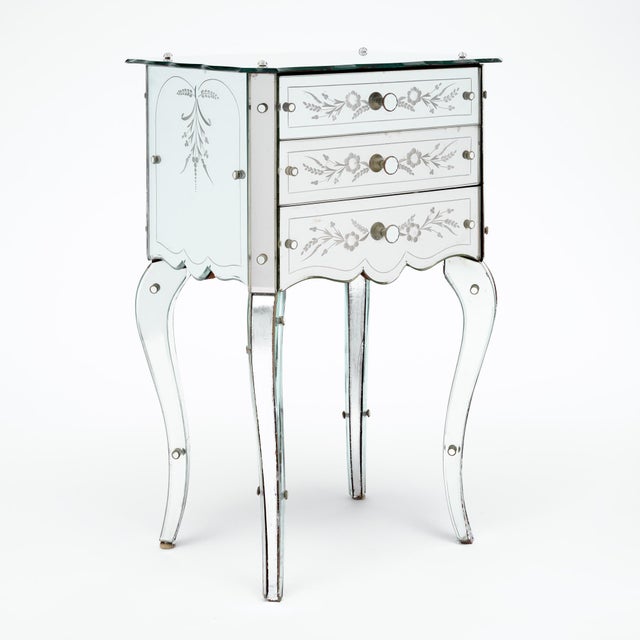 Side table from the Art Deco period in France. This single table is covered with a striking, engraved mirrored veneer. We...