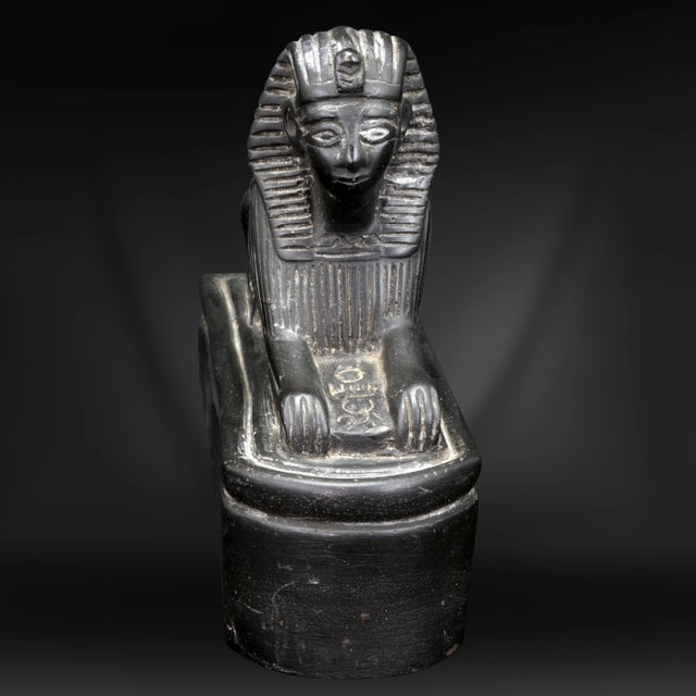 An ancient-looking carving of an Egyptian sphynx that was carved from black slate during the height of “Tutmania” in the...