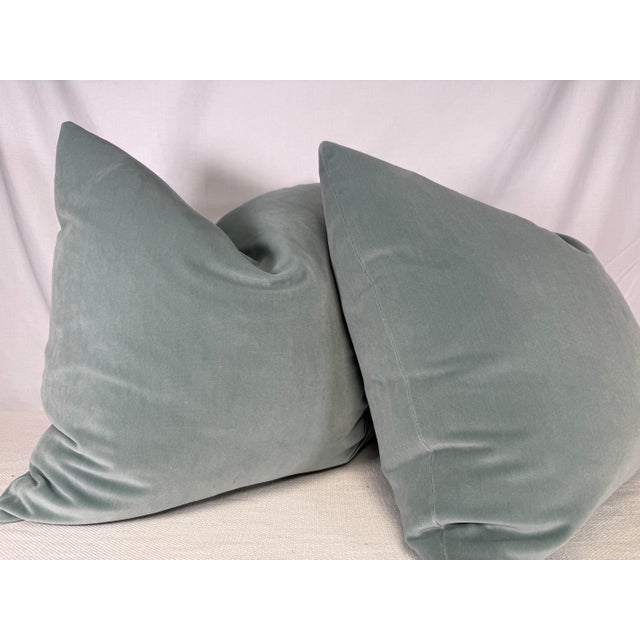 Custom pair of 22" pillows coverd in a soft cotton velvet in aqua blue. These pillows have tapered corners to prevent dog...