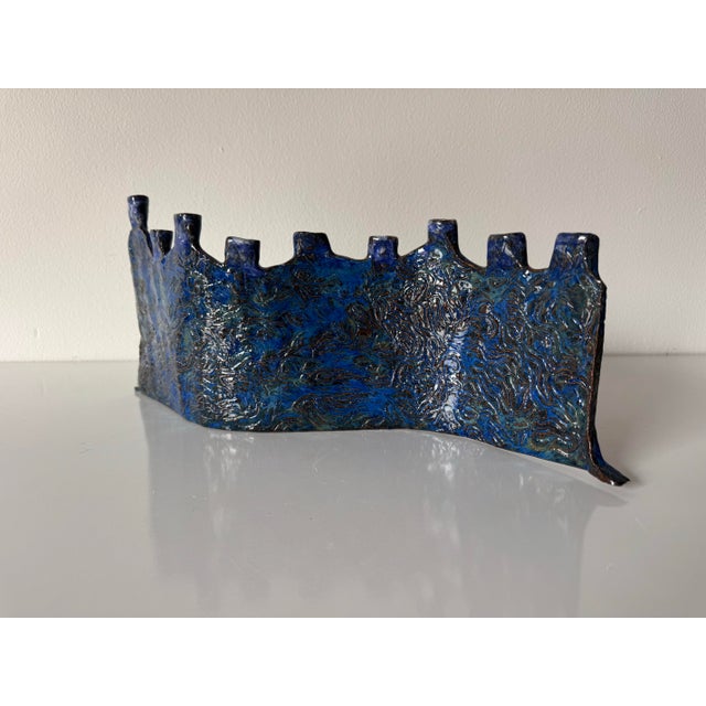 Unique vintage handmade ceramic menorah C. 1990s, featuring a striking sculptural form with an undulating, wave-like...