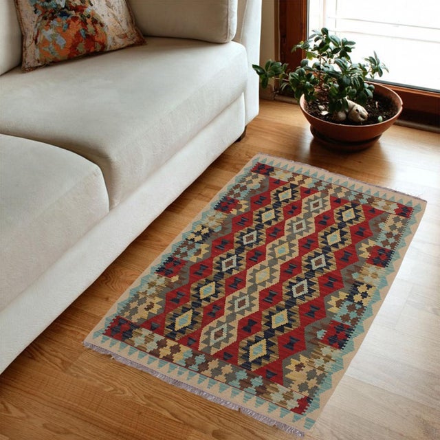 Add a touch of elegance to your home with this casual chic hand woven Tribal Kilim wool rug. Constructed on a loom by...