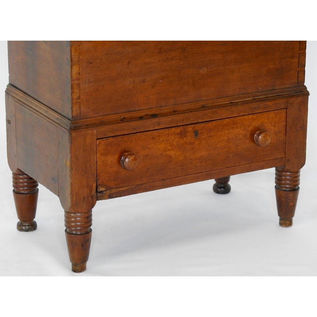 We are offering a primitive cherrywood sugar chest with beehive legs from the 19th century. It has one drawer in the...