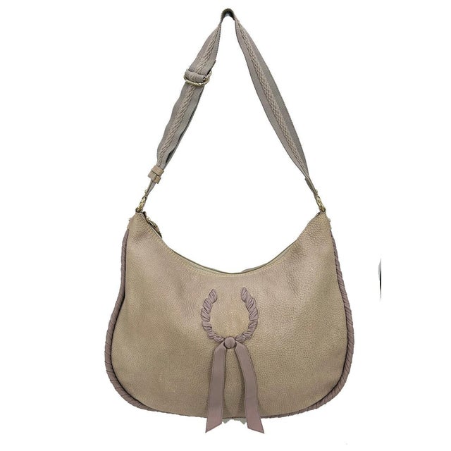 Nina Ricci Gray Leather Hobo Shoulder Bag in good condition. Gray pebbled leather body trimmed with taupe leather wrapped...