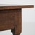 A French side table in the Louis XVI style, dating to circa 1800, featuring a structured wooden frame with balanced...