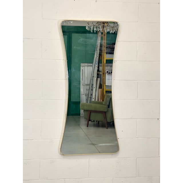 Large shaped mirror from the 50s, brass frame, the upper part of the mirror inside has 3 drops of silver plating (see photo)