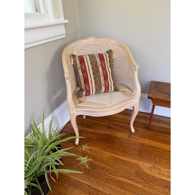 Square woven chenille pillow in red, green and cream vertical stripes with kilim style diamond and arrow motifs in...