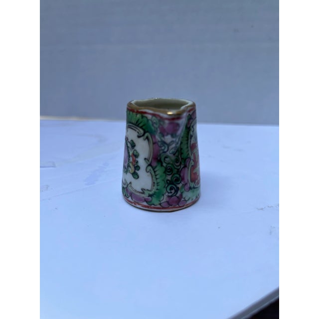 A single very small Chinese export porcelain pitcher with handle featuring traditional rose medallion decoration.