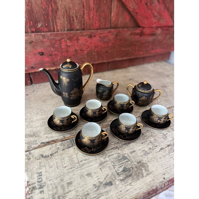 This vintage Kutani tea set features a stunning matte black and gold hand-painted design with scenic Japanese landscapes....