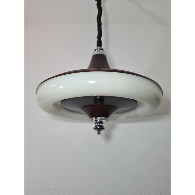 An original UFO/saucer pendant lamp, manufactured by the Belgian company Massive in the late 1960s – early 1970s. The...