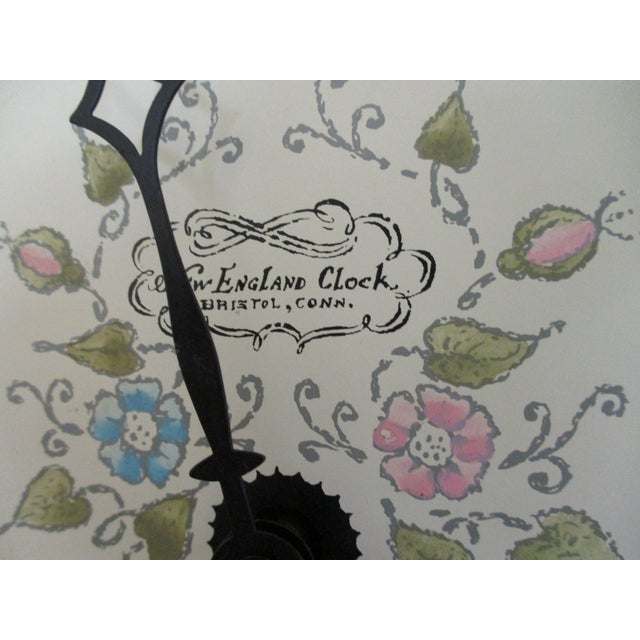 The Vintage New England Clock with a brown wooden frame, brass accents, and glass elements is a charming addition to any...