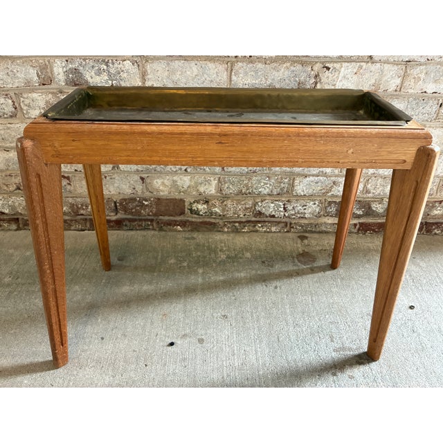 Vintage brass and wood "flower" side table. This 1960s Danish wooden end table has a brass inset table top that was once...