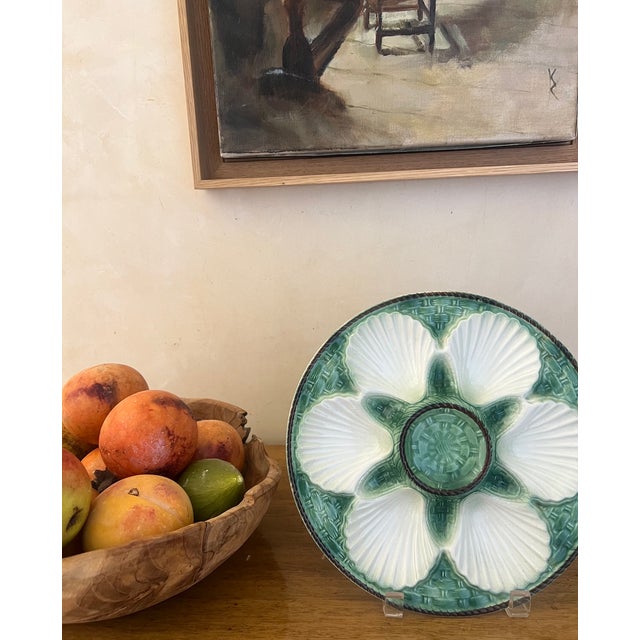 Classic French green and white majolica oyster plate with white shell design wells for oysters and a center well for...