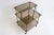 Jewel of a high quality brass and smoked glass serving trolly on castors in Maison Jansen , Maison Baguès Style. Made in...