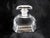 This is a cut crystal perfume bottle with a matching stopper. The bottle is rectangular shaped with cut off corners and a...