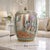 Large vintage Chinese Rose Medallion porcelain jar featuring vivid hand‑painted birds, florals, and fruit motifs in rich...