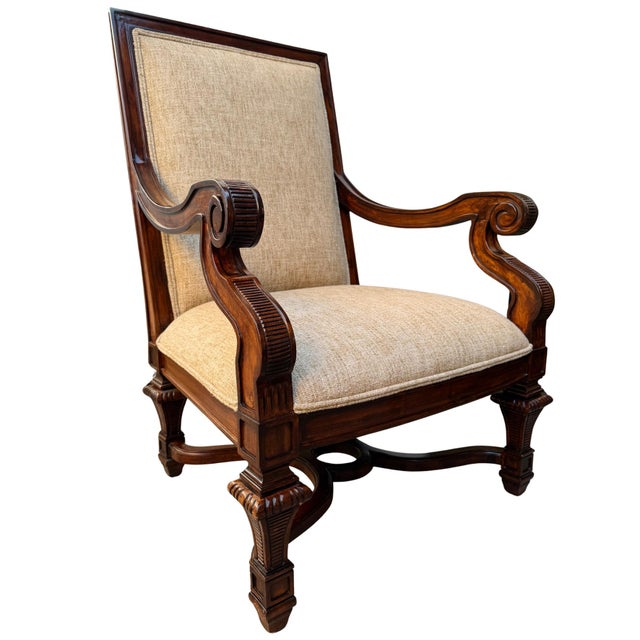 A grand pair of oversized Neoclassical revival armchairs hand-carved from rich mahogany. Featuring dramatic rolled scroll...