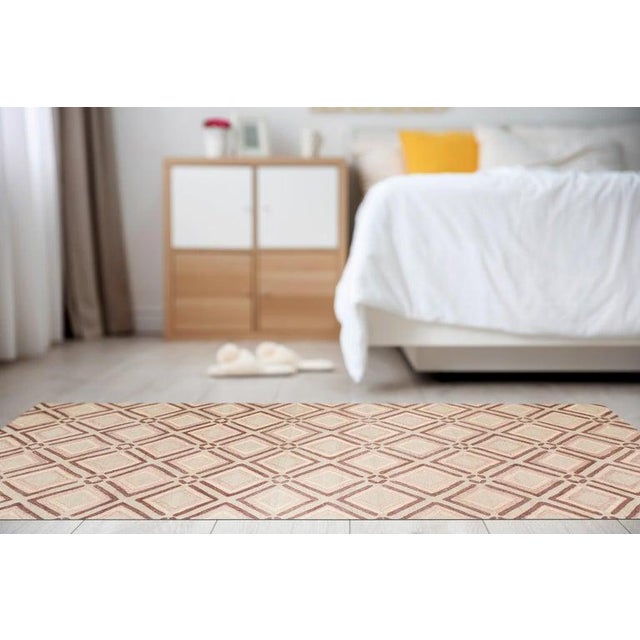 This hand knotted pile rug features a primary color palette of ivory, beige, cream, and white. Made from wool, this floor...