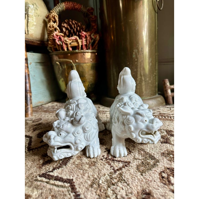Striking vintage Otagiri Japan porcelain Foo Dogs, crafted in luminous white glazed ceramic with finely detailed facial...