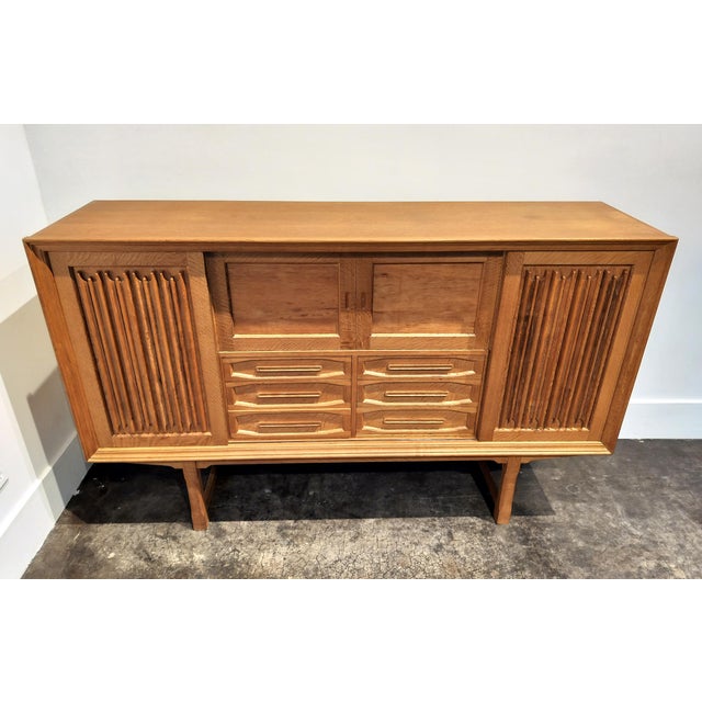 Mid-Century Danish oak wood sideboard circa 1960s, designed and manufactured by Henning Kjaernulf. Sculptural, carved wood...