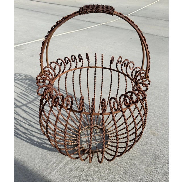 Vintage Iron Gathering Basket with a rusty finish. Curly trim with twisted basket detail. Great for display outside with...